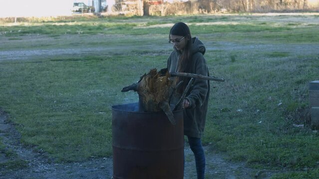 Young Woman Tends To Trashcan Fire In Rural America Countryside BMPC4K