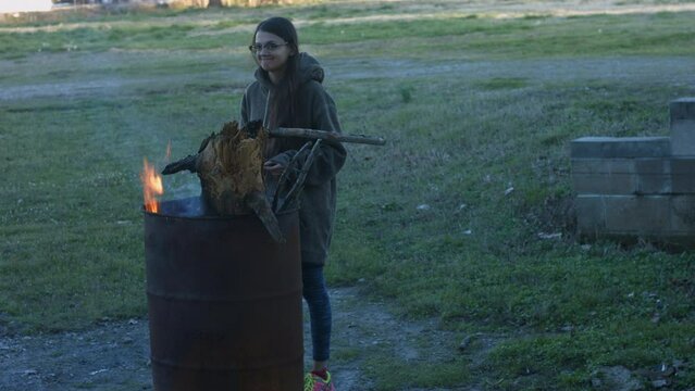 Young Woman Tends To Trashcan Fire In Rural America Countryside BMPC4K