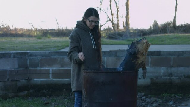 Young Woman Tends To Trashcan Fire In Rural America Countryside BMPC4K