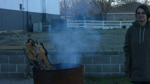 Young Woman Tends To Trashcan Fire In Rural America Countryside BMPC4K
