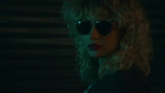Latina woman with sunglasses smoking vapear 