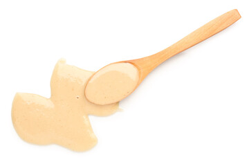 Wooden spoon with tasty tahini on white background