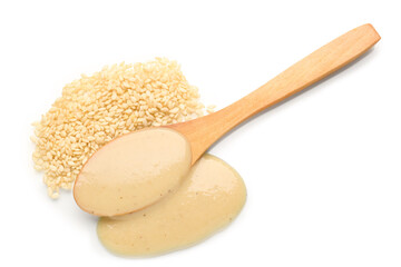Wooden spoon with tasty tahini and sesame seeds on white background
