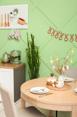Interior of modern kitchen with table served for Easter celebration
