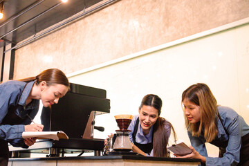 An experienced female barista in uniform will demonstrate how coffee is made and provide a master class. Small business and cafe owner concept