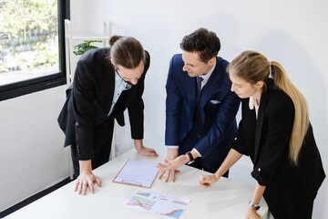Group of business people brainstorming at table to work. Effective people in organization use idea to consult their work.