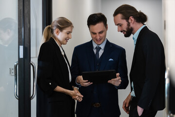 Group of business people brainstorming using a tablet to work. Effective people in organization use idea to consult their work...employees drive company.