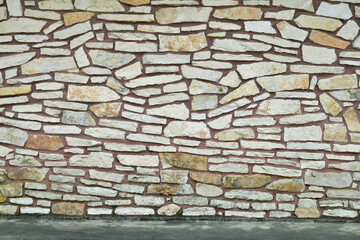 Rock stone wall building siding sidewalk