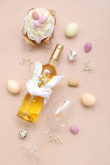 Composition with bottle of wine, glass, Easter cake and eggs on color background