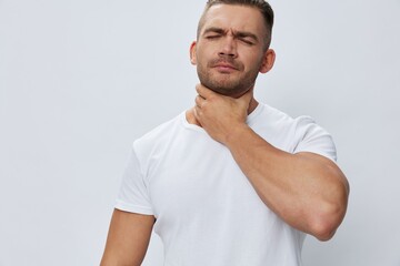 Man sore throat and cough, cold and flu, allergies, pain, in white t-shirt on white isolated background, copy space