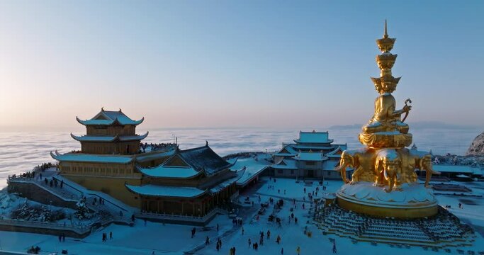 Aerial view of Emei mountain golden summit in the snow winter sunrise morning with sea of clouds Emeishan Buddhist temple