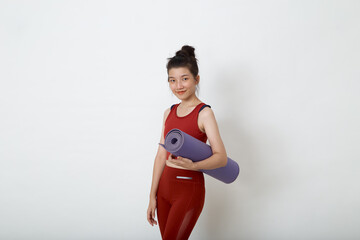 woman with sportswear holding yoga mat