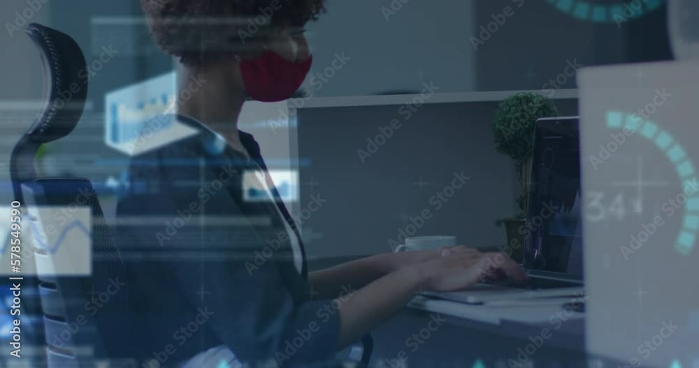 Wall mural Animation of data processing over biracial businesswoman with face mask in office