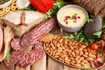 Salami sausage close-up. Table full of mediterranean appetizers, tapas or antipasto. Assorted Italian food set. Delicious snack on party or picnic time. Meat and cheese. Italian style banquet. 