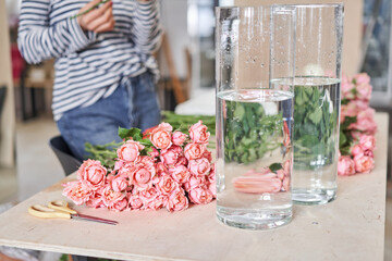 Bush rose Juliet. Florist prepares flowers. Fresh delivery in flower shop. European floral shop. Delivery fresh cut flower.
