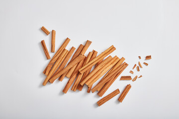 Top view of cinnamon sticks (Cinnamomum) isolated on white background. Scene for advertising product of cinnamon extract. Medicinal herbs, cooking spices, cosmetic flavorings