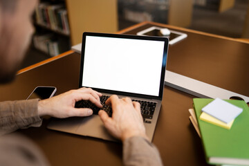 Freelancer copywriter typing on keyboard using laptop computer working project online sitting at...