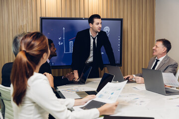 Diverse colleagues gather in brainstorm discuss statistics together. Group of people colleagues gather doing Brainstorming business plan together. Team Brainstorm Working Concept.	