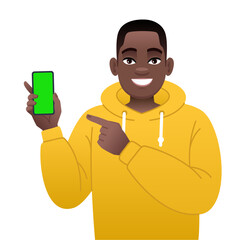 Young black man points to the screen of a smartphone in his hand. Advertising of a mobile application or services, promotion of an application or website.