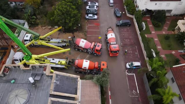 Aerial view of concrete mixer vehicles on building construction site, Tel Aviv, Israel