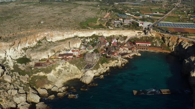 Popeye Village Malta - Film Set Village Converted Into A Theme Park In Anchor Bay, Island Of Malta. Aerial Shot