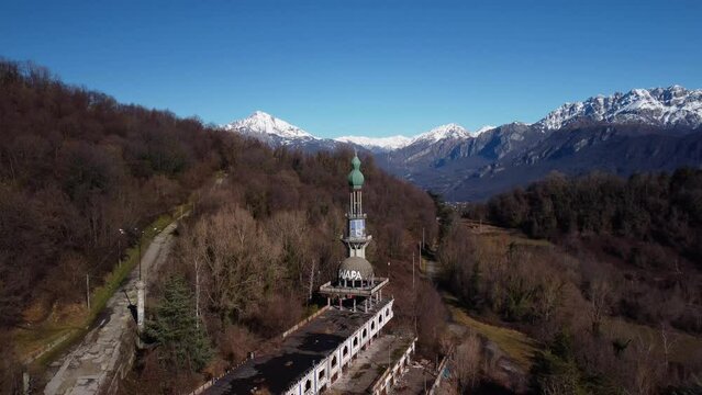 Minaret at Consonno ghost town, aerial establisher view, sunny winter day