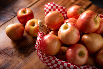 Several Royal Gala Apples (malus domestica) on wooden rustic table..Apple trees are cultivated worldwide and are the most widely used species of the genus Malus.