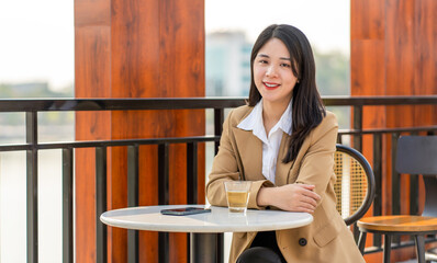 Asian businesswoman working outside the cafe corridor