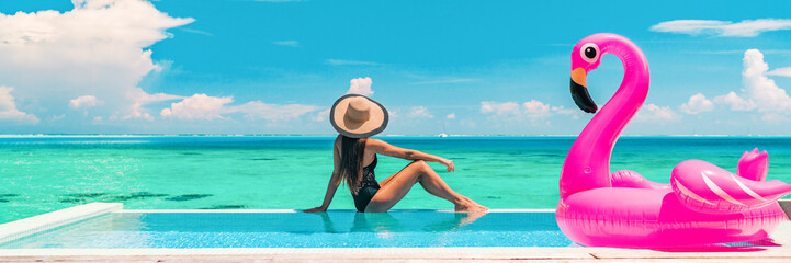 Vacation swimming pool banner luxury travel background woman relaxing by infinity overwater bungalow with pink flamingo float fun holiday concept panorama © Maridav