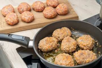 close-up, cooking meatballs in a frying pan