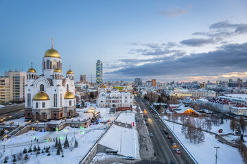 Winter Yekaterinburg and Temple on Blood in beautiful cloudy sunset. Aerial view of Yekaterinburg, Russia. Translation of the text on the temple: Honest to the Lord is the death of His saints.