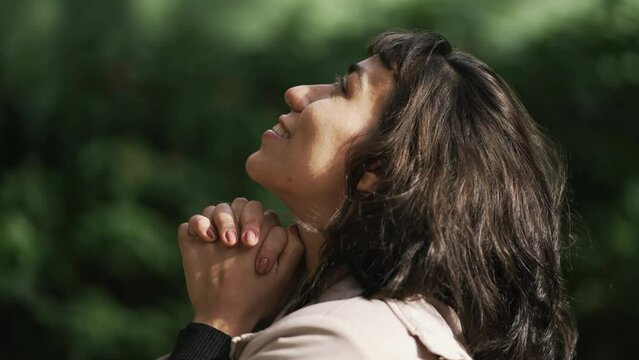 Profile of South American person praying to God. A grateful hispanic woman in prayer feeling gratitude and grace