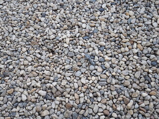 Pebbles of different shapes, sizes, and colors. Small boulders on the beach or decorate your home garden.Outdoor background design
