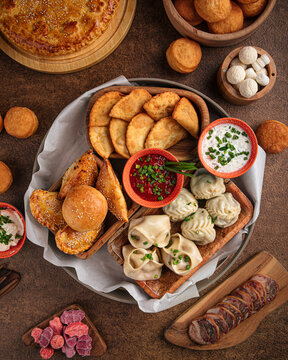 Set of assorted oriental cuisine dishes with samsa and manti