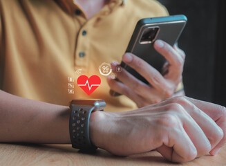 young man checks and monitors his heart rate through an app in a smart watch.smartwatch with heart icon on screen.