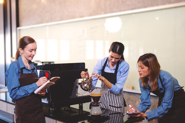 An experienced female barista in uniform will demonstrate how coffee is made and provide a master class. Small business and cafe owner concept