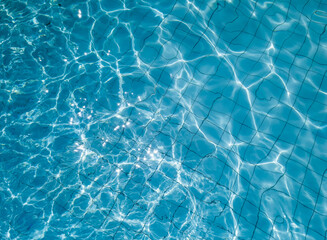 Fototapeta na wymiar Ripple Water in swimming pool - ripple water with sun reflection