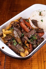 Sizzling Lomo Saltado Delight on Wooden Table