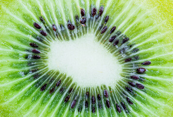 Green fruit kiwi close up, green background. Kiwi with seeds close-up. Food concept. Macro concept.