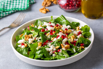 Arugula salad with cheese served with walnuts and pomegranate. Turkish name; Roka salatasi