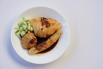 Pempek is a savoury Indonesian fishcake delicacy, made of fish and tapioca from Palembang. Pempek is served with sweet and sour sauce.