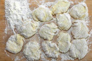 Prepared pieces of wheat flour dough for baking pies