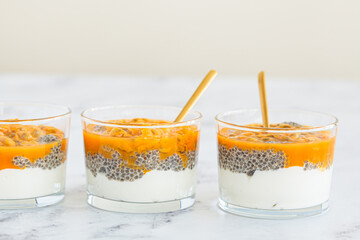 Chia pudding with passion fruit and coconut yogurt in glass. Healthy vegan recipe.