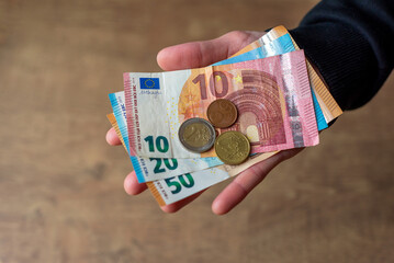 Euro money in hand banknotes and coins. 