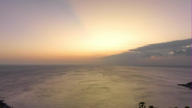 aerial hyperlapse view light through the sky at Promthep cape.Promthep cape viewpoint is the most popular viewpoint in Phuket island..Beautiful Sunset Sun Cirrus Clouds in Colorful Sky.