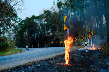 The Roadside Pillar rubber para pole is burning with flames and there is smoke rising from the fire...