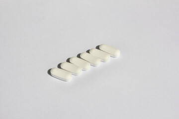 white pills on a white background