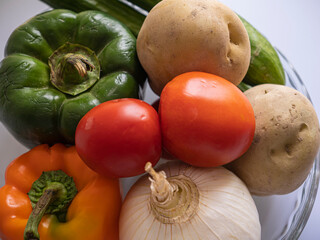 Pepper . tomato . Cucumber . potato . an onion . Garlic . raw .