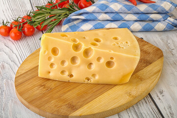 Maasdam cheese piece over board