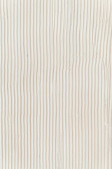 Surface of the wall with a decorative white plaster. Textured concrete wall with vertical lines.